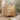Wooden dresser with floral patterns in a room with plants and decor